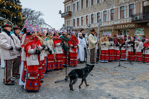 Uzhhorod, Ukraine - December 27, 2021: People in traditional Hutsul costumes sing Christmas carols known as \