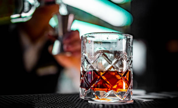 istock man hand bartender making negroni cocktail in bar 1361486214
