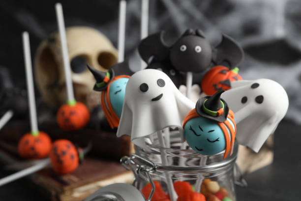 istock Different Halloween themed cake pops on dark background, closeup 1361489191