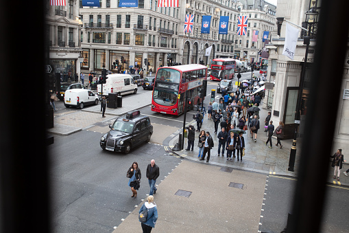 High angle view on intersection in London, Oxford Street and Regent Street with pedestrians on sidewalk and traffic