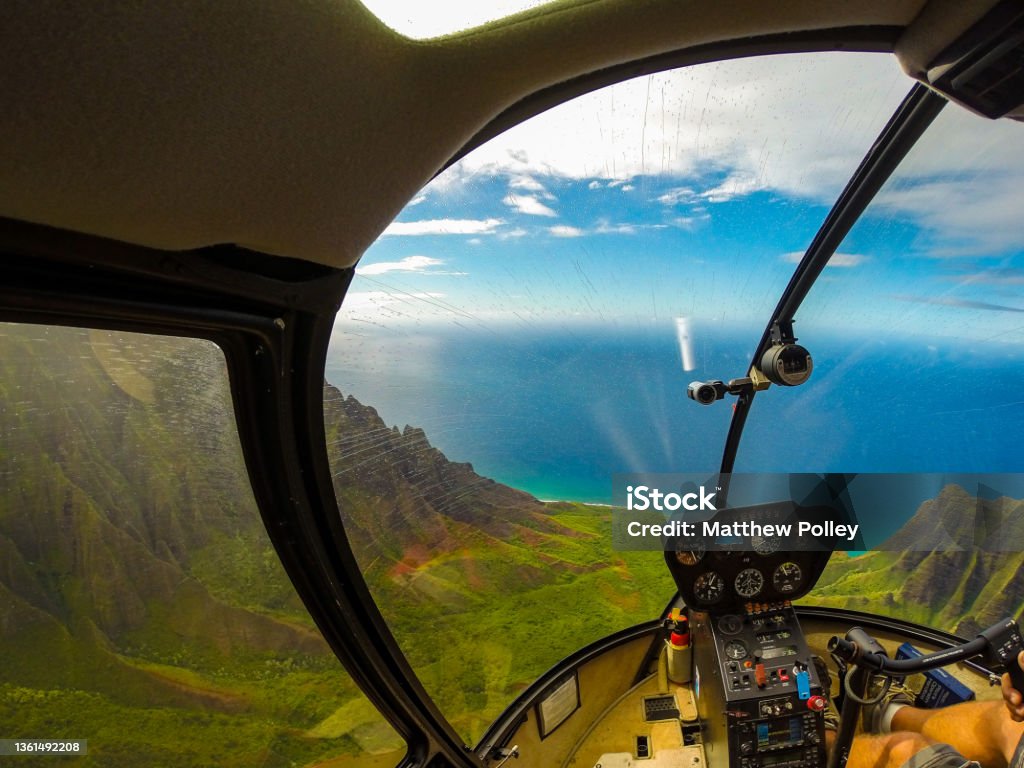 flying over coastal valley in helicopter helicopter flight over coast in kauai hawaii Helicopter Stock Photo