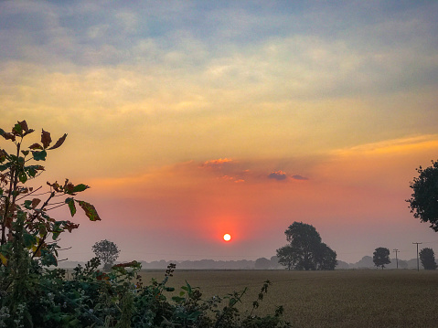 sun rises over English countryside in summer