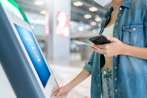 istock smart asian female traveller self checking in for flight transport at gate counter machine scaning monitor device at airport check in counter,smart technology travel ideas concept at terminal 1361493198