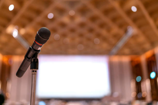 Microphone in meeting room for a conference.Public speaking backgrounds, Close-up the microphone on stand for speaker speech presentation stage performance