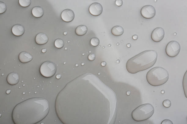 istock Drops of spilled water on grey background, top view 1361494024