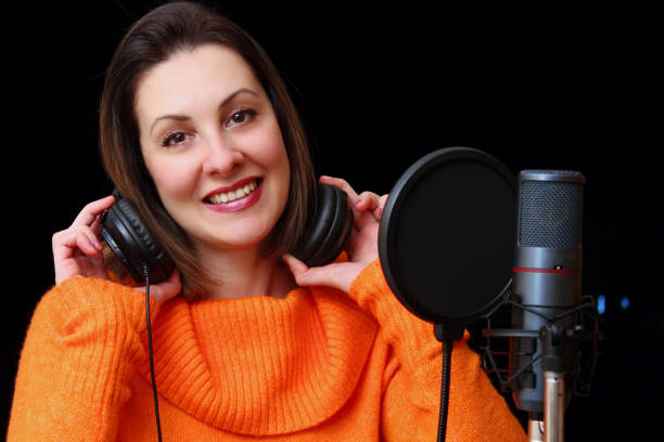 istock Woman With Headphones And Studio Microphone 1361495176