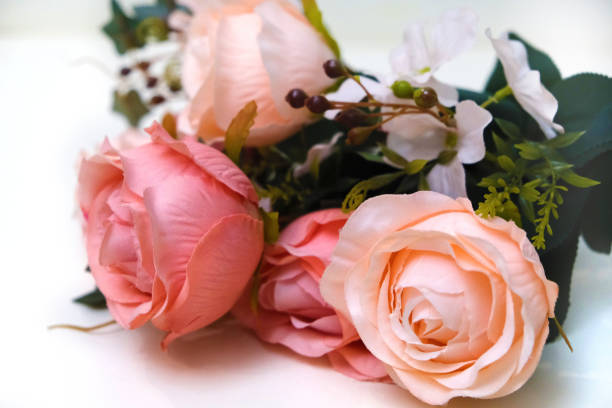 istock Bouquet of artificial pink roses on white background, home decor 1361496421