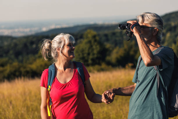 istock Active senior couple hiking in nature with backpacks, enjoying their adventure at sunset. 1361496708