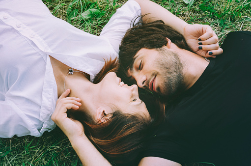 Happy couple lying in the grass