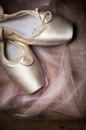 Pointe shoes on wooden background