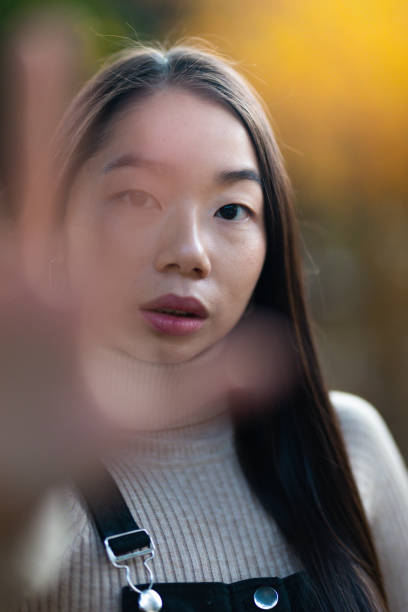 istock Young teenage asian model showing stop gesture with hands. 1361511272