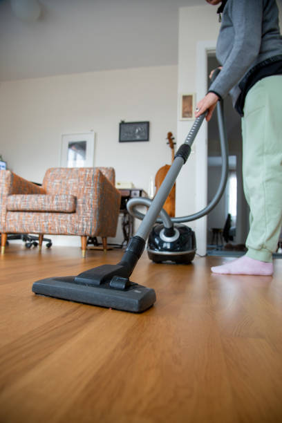 istock Woman vacuuming house 1361512245