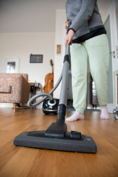 istock Woman vacuuming house 1361512415