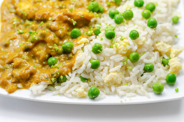 Chicken curry with egg fried rice, chicken breast pieces in a mildly spiced coconut curry sauce with fried rice with peas and egg