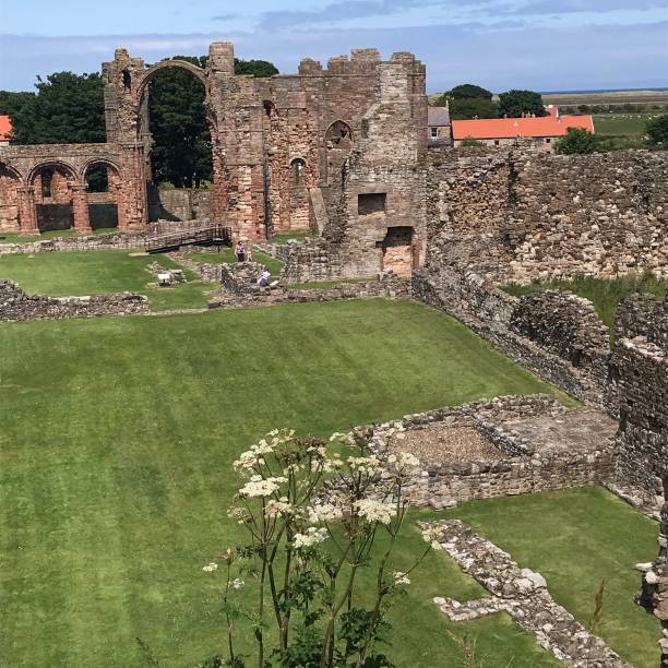 Lindisfarne Priory, Northumberland, England Lindisfarne Priory, Northumberland, England lindisfarne monastery stock pictures, royalty-free photos & images