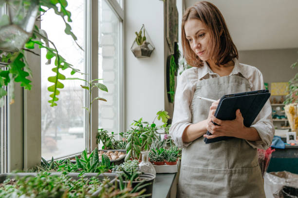 istock Young woman wearing apron standing at her workshop 1361513992