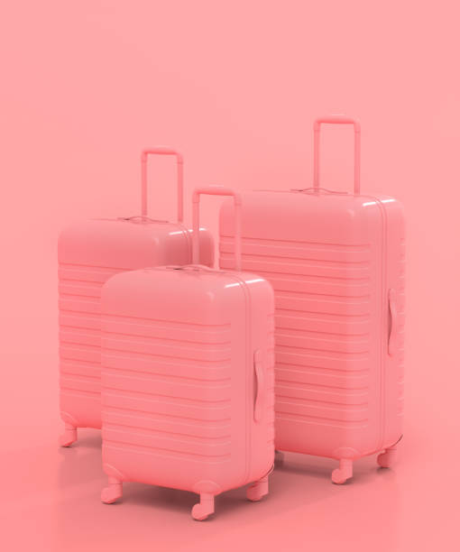 istock Suitcase with beach ball and flip flops on monochrome pink background. 1361514998