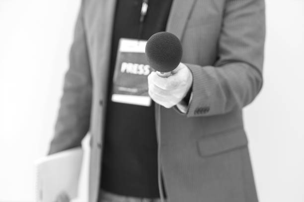 istock Journalist holding microphone making media interview. Journalism concept. 1361517747