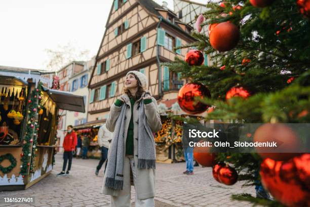 Woman Walking Near The Christmas Tree In City Centre Stock Photo - Download Image Now