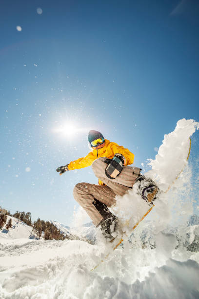 Woman snowboarding at ski resort stock photo