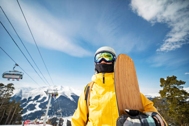 istock Woman snowboarding at ski resort 1361533366