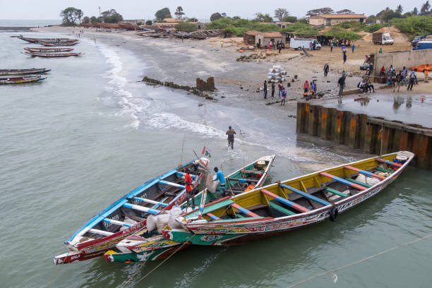 Barra, The Gambia - June 24, 2019: Coast and boats moored in the port of the ferry terminal