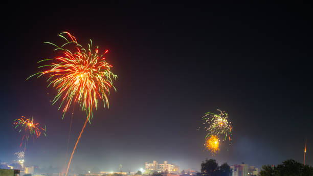 istock Handheld slow motion shot firework in the sky during the new year celebration. Background for new year party. Shining fireworks with bokeh. New year's eve firework celebration. 1361543449