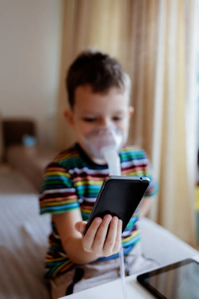istock Sick little boy wearing oxygen mask. 1361544239