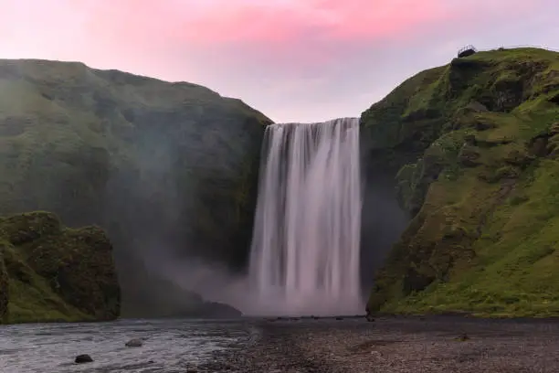 View of a majestic waterfall at dusk. Skogafoss waterfall, Iceland.