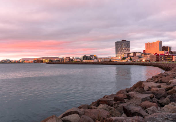 Reykjavik waterfront in midnight light in summer View of Reykjavik waterfront and skyline in midnight sun light in summer midnight sun stock pictures, royalty-free photos & images