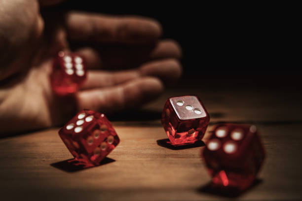 istock hand rolling dice. risk, luck and gambling concept 1361558106