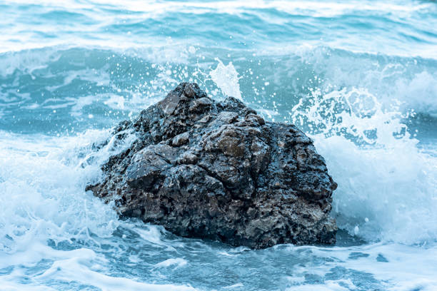 coastal rock in the surf during stormy weather