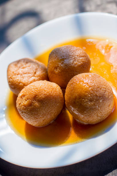 sugar filled roll, commonly known as "Rasgulla" or " Nolen Gurer Rosogolla" in Bengali is made of new Jaggery and Curd. sugar filled roll, commonly known as "Rasgulla" or " Nolen Gurer Rosogolla" in Bengali is made of new Jaggery and Curd. rosogolla stock pictures, royalty-free photos & images