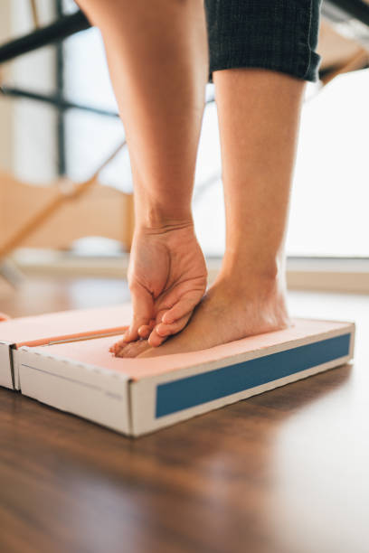 chiropodist taking the shape of a patient's foot with a foam mold for the manufacture of a special insole. - podiatrist podiatry pedicure chiropodist imagens e fotografias de stock