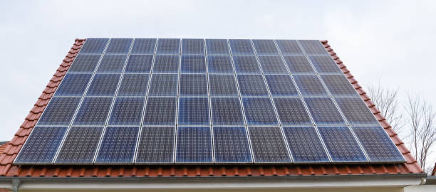 istock Photovoltaic solar modules on a clay tile roof in Germany. 1361570858