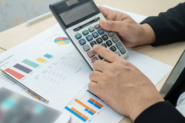 istock Asian accountant working and analyzing financial reports project accounting with chart graph and calculator in modern office, finance and business concept. 1361571890