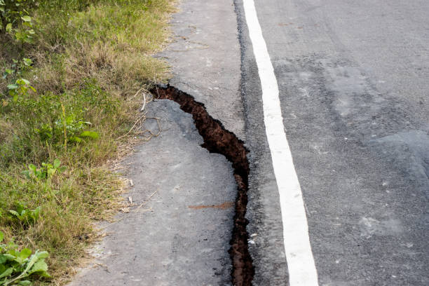 istock Broken asphalt road in the hillside due to earthquake 1361572809