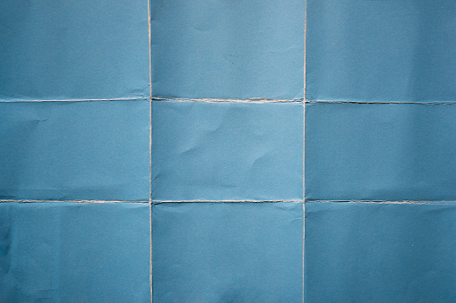 Papel azul doblado en nueve fracciones de fondo photo