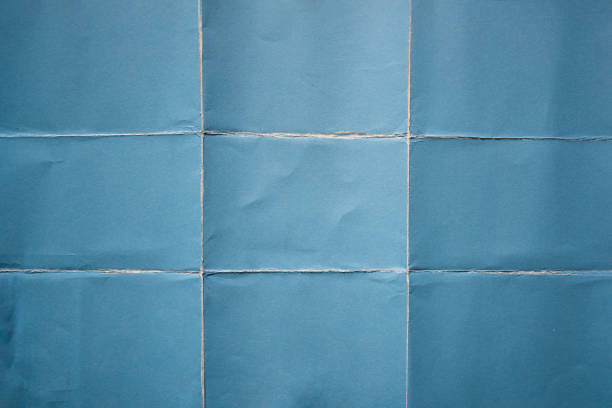 papier bleu plié en neuf fractions de fond - plié photos et images de collection