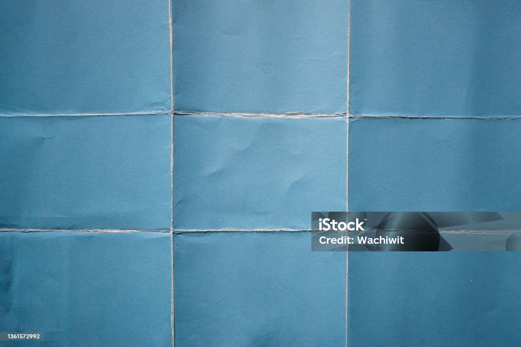 Blue paper folded in nine fraction background Paper Stock Photo