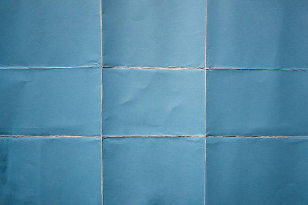 blue paper folded in nine fraction background - paper folded crumpled textured imagens e fotografias de stock