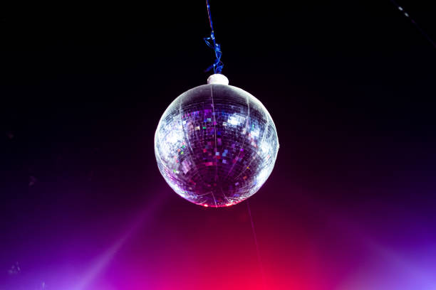 istock A hanging disco ball with laser lights falling on it. Selective Focus on ball. 1361573124