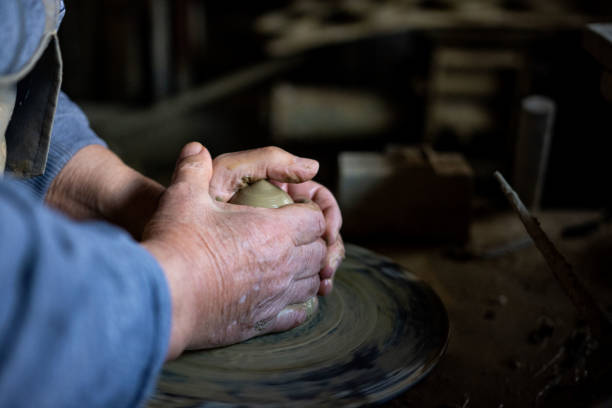 istock Cropped hands of potter making pot 1361577251
