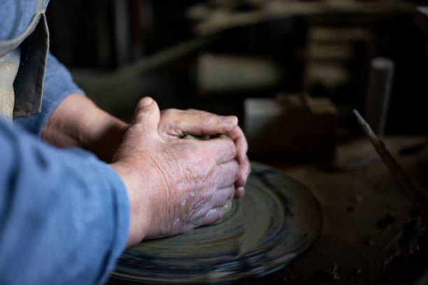 istock Cropped hands of potter making pot 1361577272