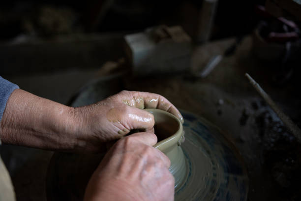 istock Cropped hands of potter making pot 1361577301