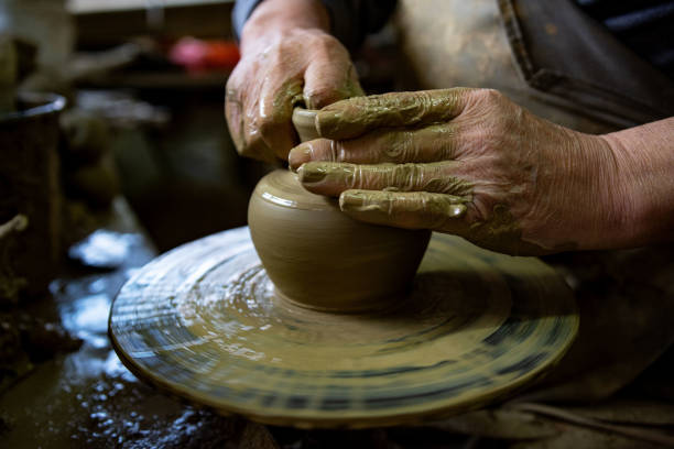 istock Cropped hands of potter making pot 1361577453