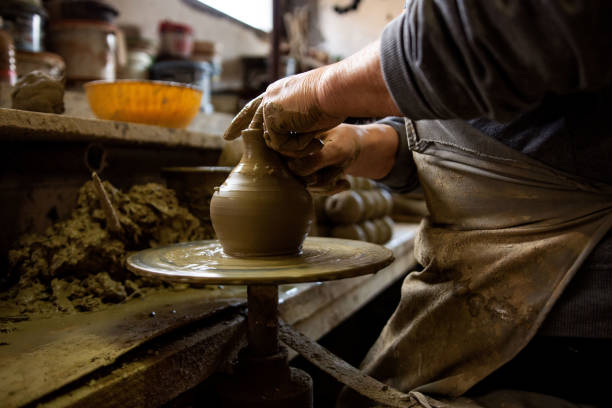 istock Cropped hands of potter making pot 1361577994