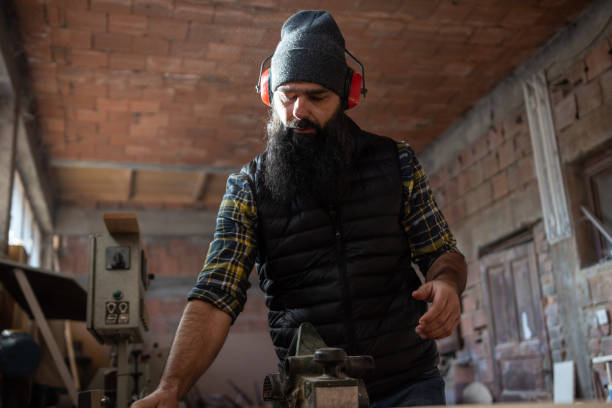 istock Young repairman working in carpentry workshop 1361578604
