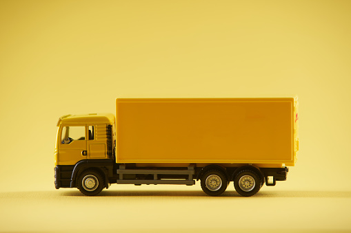 yellow toy  truck against yellow background