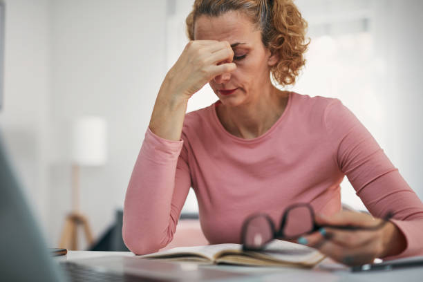 istock Woman with eyes hurting, sinus problem, headache, head pain, working from home troubles and issues. 1361580955